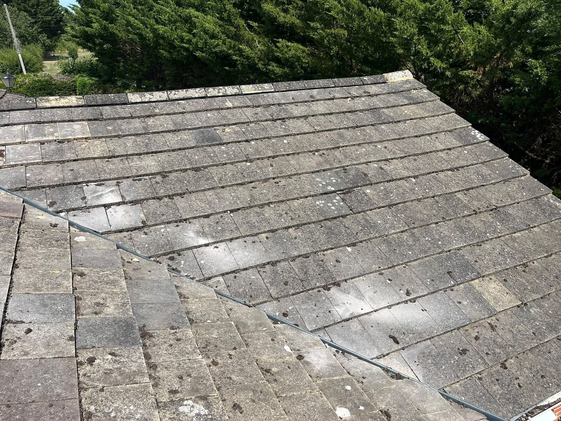 A plain tiled roof where two slopes meet in a valley