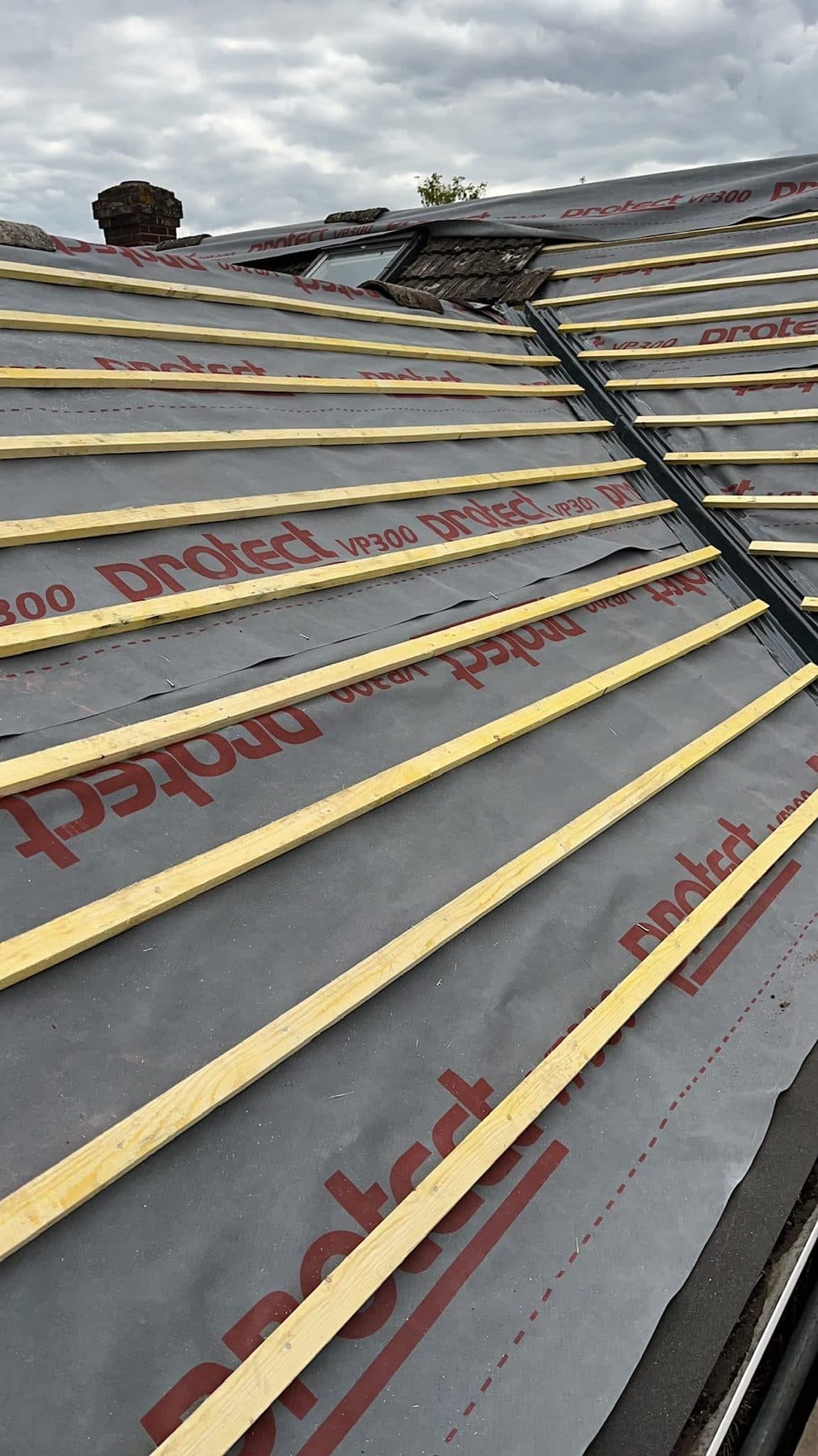 New membrane and battens on two roof slopes either side of a valley